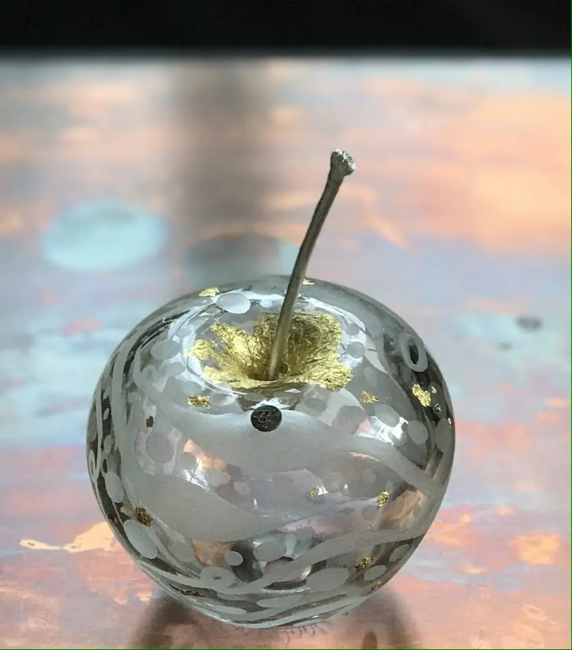 A Happy Apple glass sculpture