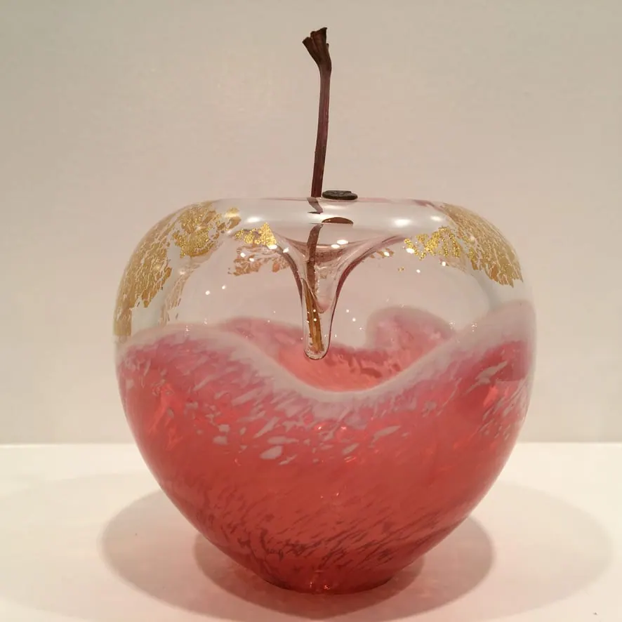 A Happy Apple glass sculpture
