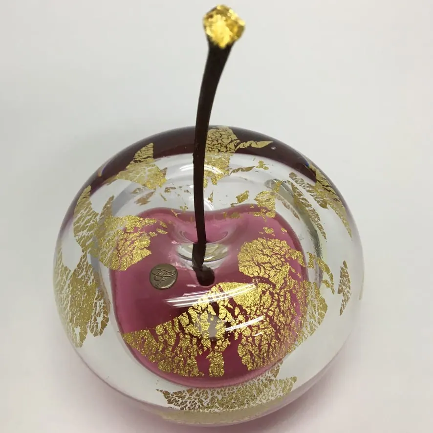 A Happy Apple glass sculpture